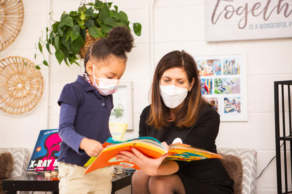 Nina Rees reads to a student while visiting Friendship Public Charter School’s Blow Pierce campus in Washington last year. (National Alliance for Public Charter Schools)