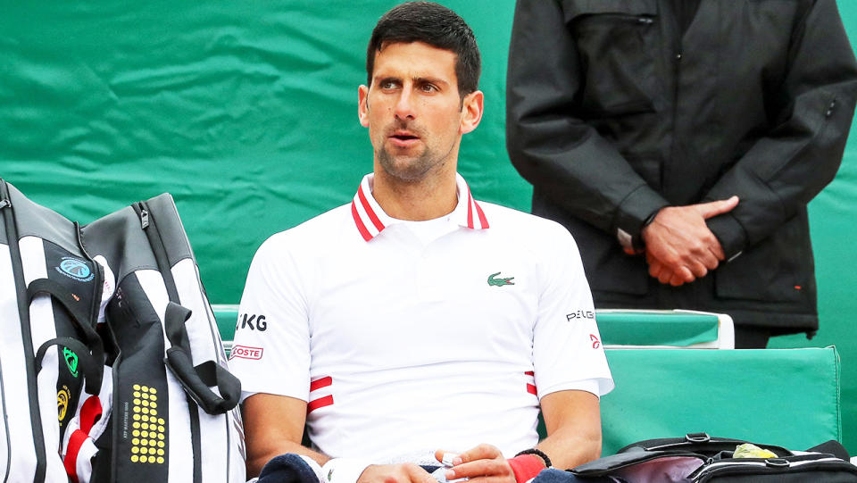 Novak Djokovic (pictured) looking dejected following his loss to Evans.