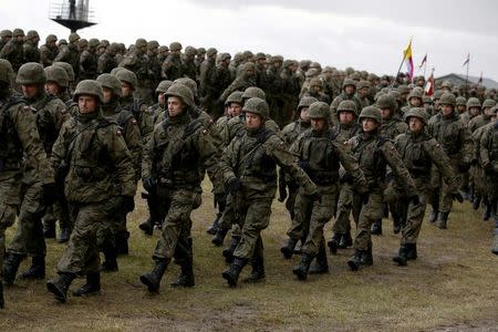 Polish soldiers attend welcoming ceremony for U.S.-led NATO troops at polygon near Orzysz, Poland, April 13, 2017. REUTERS/Kacper Pempel