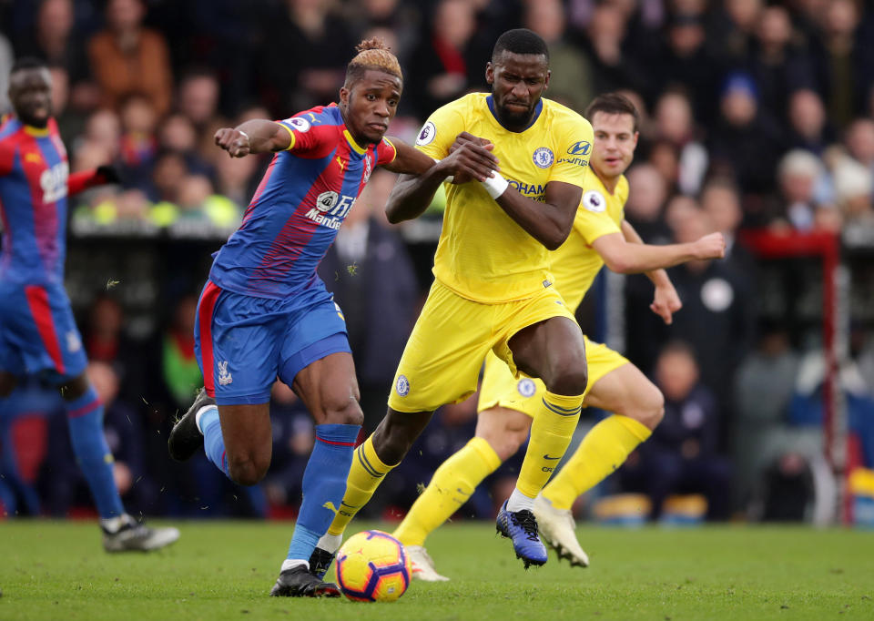 Palace’s Wilfried Zaha (left) is challenged by Antonio Rudiger