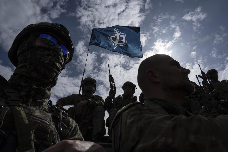 FILE - Fighters of Russian Volunteer Corps stand atop on an APC during press conference not far from the Ukraine's border with Russia in Sumy region, Ukraine, on May 24, 2023. Fighters from Ukraine made an attempt to cross into the town of Tetkino, which lies right on the border, the governor of Russia’s Kursk region, Roman Starovoit, said Tuesday. (AP Photo/Evgeniy Maloletka, File)