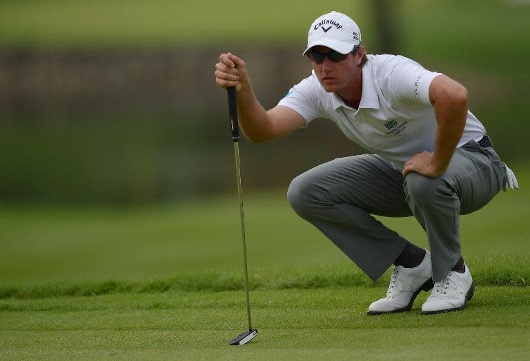 Nicolas Colsaerts lines up a putt on the 13th green during the second round of the Maybank Malaysian Open in Kuala Lumpur on April 18, 2014