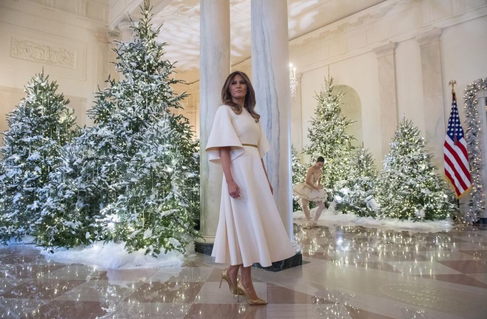 <p>Mrs. Trump or Mrs. Claus? Melania stuck with a tried and true favorite, Dior, to unveil the White House Christmas decorations in November 2017.</p>