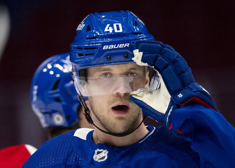 Vancouver Canucks' Elias Pettersson adjusts his helmet during an NHL hockey practice in Vancouver, British Columbia on Saturday, March 2, 2024. Pettersson resigned to the team with an eight year contract extension. (Ethan Cairns/The Canadian Press via AP)