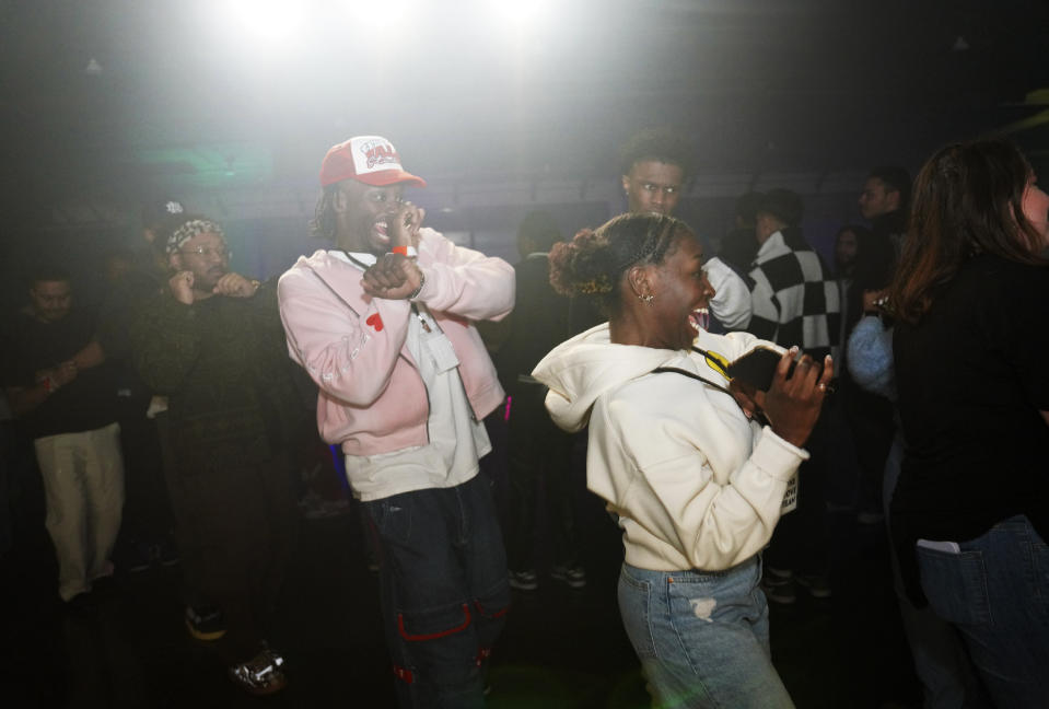 Jonathan Diggs, center, and Carlyle Coppins, right, join in a line of dancers at The Cove, a pop-up, 18-and-up Christian nightclub, on Saturday, Feb. 17, 2024, in Nashville, Tenn. (AP Photo/Jessie Wardarski)