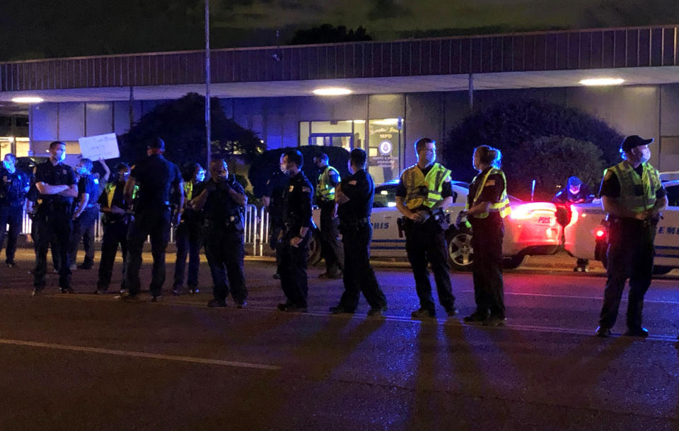 Officers form a line in front of a police precinct Wednesday, May 27, 2020, in Memphis, Tenn., during a protest over the death of George Floyd in police custody earlier in the week in in Minneapolis. (AP Photo/Adrian Sainz)