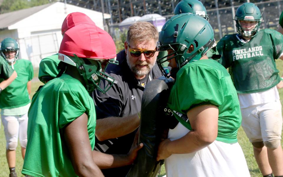 Pinelands Regional High School football head coach John Tierney works with his players during drills Wednesday morning, August 24, 2022. 