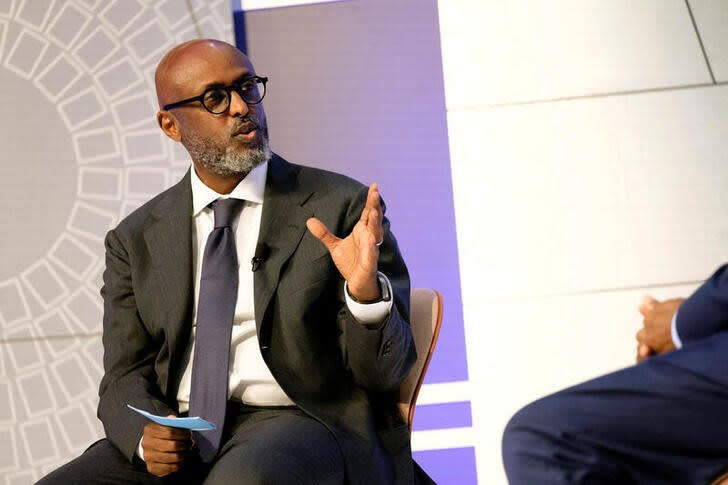 IMF African Department Director Abebe Aemro Selassie speaks with the Governor of the Central Bank of Kenya Patrick Njoroge at the headquarters of the International Monetary Fund during the group's Annual Meetings in Washington