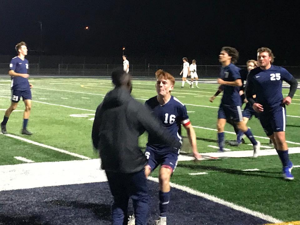 ALA Gilbert North forward Justin Provenzano (16) celebrates with assistant coach Manfred Kwarteng during a 7-2 victory over Valley Christian on Feb. 1, 2022, at ALA Gilbert North.