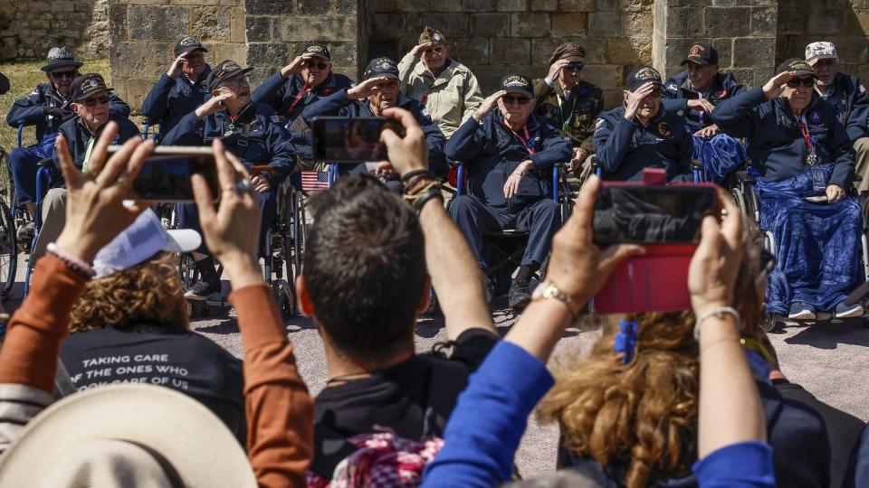U.S. veterans salute as they pose for photographs after a parade in preparation of the 79th D-Day anniversary in Sainte-Mere-Eglise, Normandy, France, Sunday, June 4, 2023. (Thomas Padilla/AP)