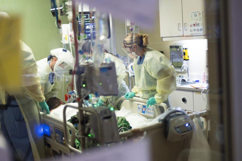 Medical professionals pronate a 39 year old unvaccinated COVID-19 patient in the Medical Intensive care unit (MICU) at St. Luke's Boise Medical Center in Boise, Idaho on Tuesday, Aug. 31, 2021. There are 208 COVID-19 patients in the St. Luke's ICU's statewide as of Tuesday. (AP Photo/Kyle Green)