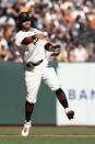 San Francisco Giants shortstop Brandon Crawford (35) leaves his feet to throw out San Diego Padres' Jake Cronenworth at first base during the eighth inning of a baseball game, Saturday, Oct. 2, 2021, in San Francisco. (AP Photo/D. Ross Cameron)