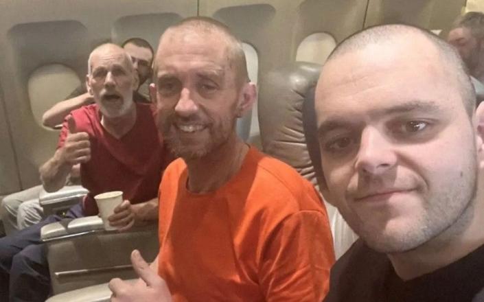 British Prisoners of war (POWs) sit in a flight following their release from Russian captivity after fighting for Ukraine, amid Russia's attack on U - INSTAGRAM/COSSACKGUNDI