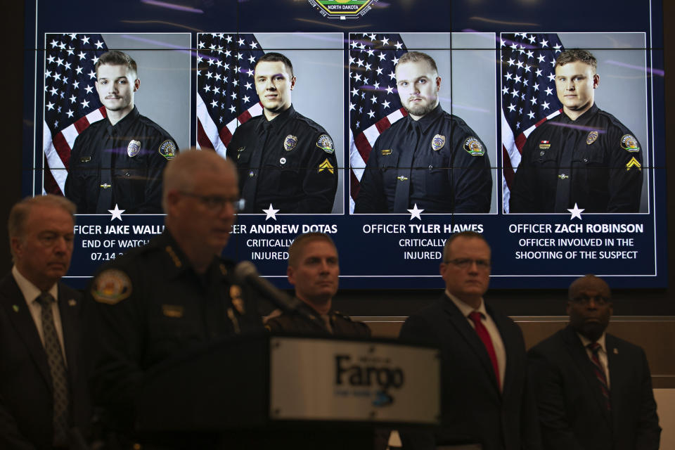 FILE - Official portraits of Fargo, N.D., police officers involved in a shooting are displayed during a news conference, Saturday, July 15, 2023, at Fargo City Hall. Officer Jake Wallin, far left, was fatally shot. Officers Andrew Dotas and Tyler Hawes were both critically injured. Officer Zachary Robinson, who killed the suspect and is on paid administrative leave, is also pictured. Law enforcement officials plan to discuss video footage on Thursday, Aug. 17, 2023, related to the shooting. (AP Photo/Ann Arbor Miller, File)