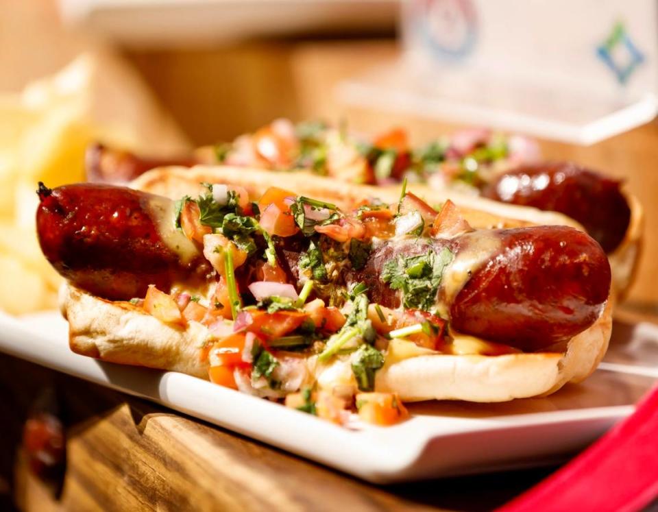 The Hurtado Barbecue poblano sausage “Oaxaca Dawwg” with queso and pico. It’s a special item for a 2023 playoff sites.