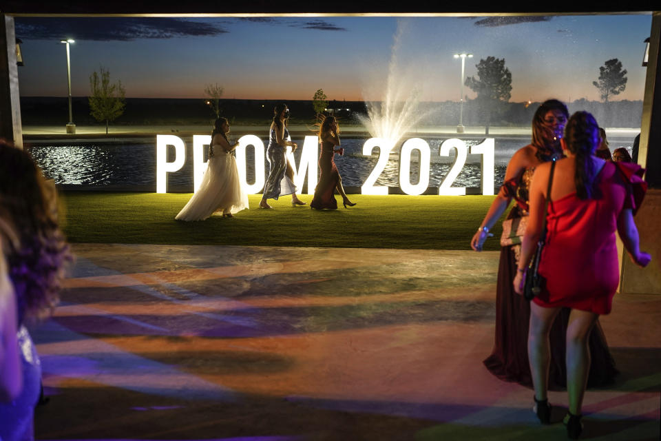 Young people attend prom at the Grace Gardens Event Center in El Paso, Texas on Friday, May 7, 2021. Around 2,000 attended the outdoor event at the private venue after local school districts announced they would not host proms this year. Tickets cost $45. (AP Photo/Paul Ratje)