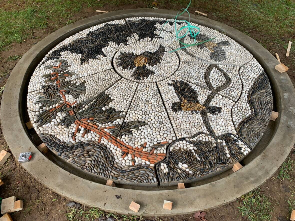 The mosaic depicts a hill, a large tree and three chickadees. Anna Camilleri, who worked alongside her team at ReDefine Arts, spoke to community members about what they’d like to see represented in the artwork.   (Katie Yealland - image credit)