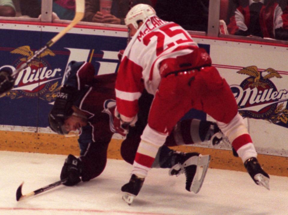 Detroit Red Wings' Darren McCarty hits and levels Colorado Avalanche's Claude Lemieux in the second period in Game 3 at Joe Louis Arena in the Western Conference finals, May 19, 1997.