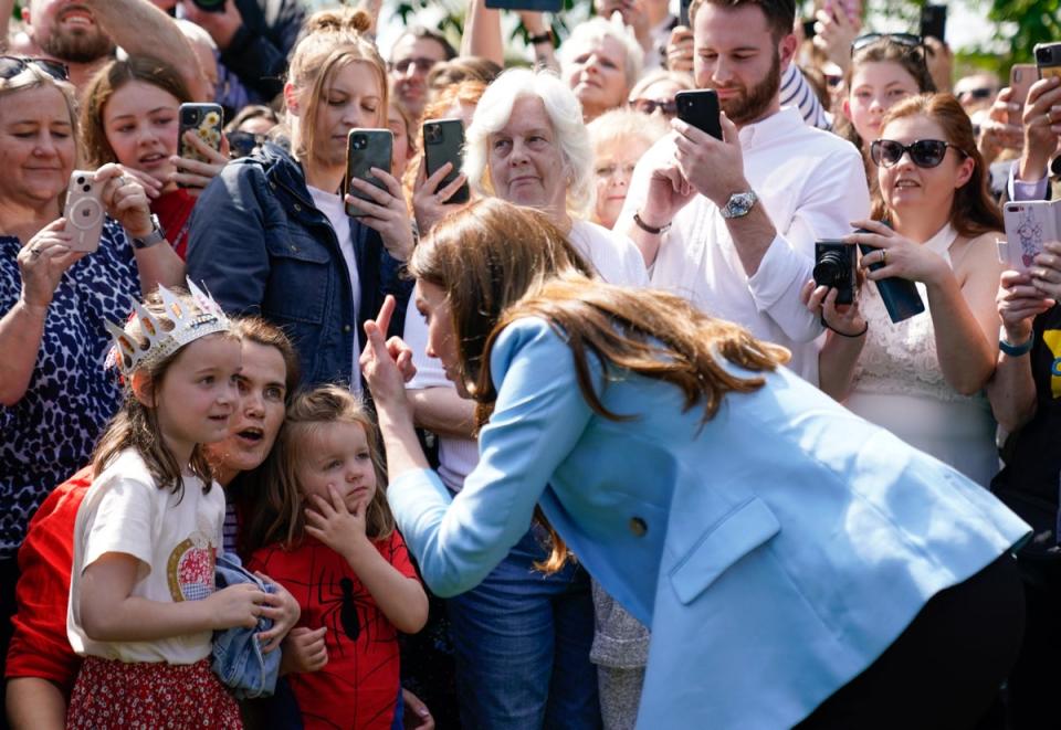 Catherine, Princess of Wales speaks to a group of children during a walkabout meeting members of the public on the Long Walk near Windsor Castle. (Getty Images)