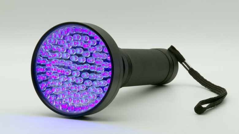 Ultraviolet flashlight against white background