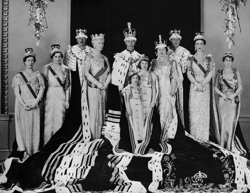 FILE - Britain's King George VI, centre, poses with his wife Queen Elizabeth, centre right, daughers Princess Elizabeth foreground centre and Margaret, along with members of the family, after his coronation, in London, May 15, 1937. Family members from left, the Princess Royal, the Duchess and Duke of Gloucester, Queen Mary, the Duke and Duchess of Kent, and Princess Maud of Norway. Queen Elizabeth II will mark 70 years on the throne Sunday, Feb. 6, 2022 an unprecedented reign that has made her a symbol of stability as the United Kingdom navigated an age of uncertainty. (AP Photo, File)