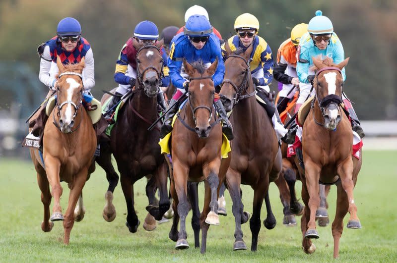 Mawj (C, blue) wins the Grade I QE II Challenge Cup at Keeneland. Photo courtesy of Keeneland