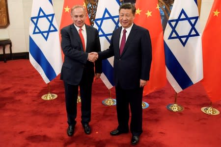 FILE PHOTO: Chinese President Xi Jinping and Israeli Prime Minister Benjamin Netanyahu shake hands ahead of their talks at Diaoyutai State Guesthouse in Beijing, China