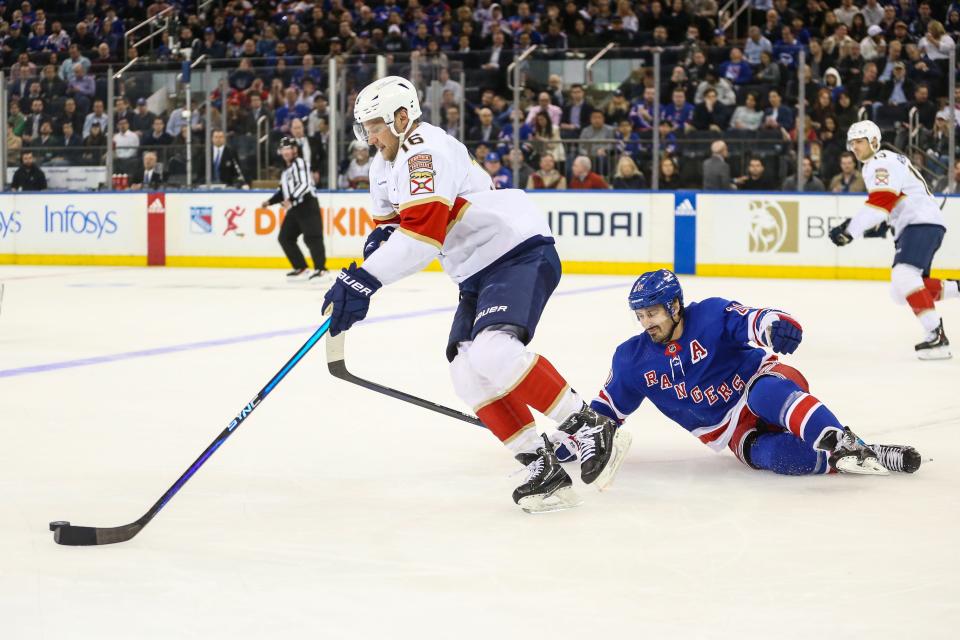 Mar 4, 2024; New York, New York, USA; New York Rangers left wing Chris Kreider (20) falls on the ice chasing after Florida Panthers center Aleksander Barkov (16) in the first period at Madison Square Garden.