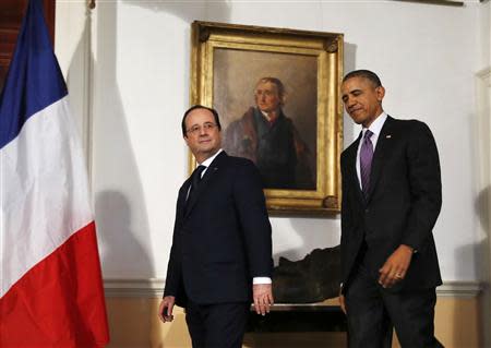 U.S. President Barack Obama (R) and French President Francois Hollande walk out to make remarks to the press after touring the Virginia residence of Thomas Jefferson at Monticello in Charlottesville, February 10, 2014. Jefferson was one of the United States' earliest envoys to France. REUTERS/Larry Downing