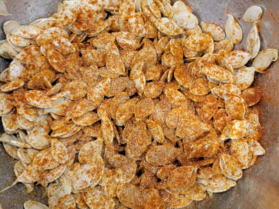 pumpkin seeds with seasoning in bowl