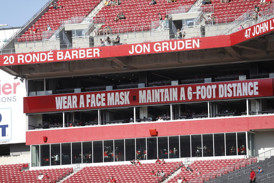 FILE - Signs that stress fans to wear a face mask are seen before an NFL football game in Tampa, Fla., in this Sunday, Oct. 18, 2020, file photo. Anyone visiting Tampa's popular outdoor destinations for the Super Bowl will be required to wear a mask to help prevent the spread of the coronavirus. Tampa Mayor Jane Castor signed an executive order Wednesday, Jan. 27, 2021, saying masks must be worn outside while downtown, in neighborhoods around Raymond James Stadium — where the Super Bowl will be held — and in other tourist hotspots.(AP Photo/Octavio Jones, File)