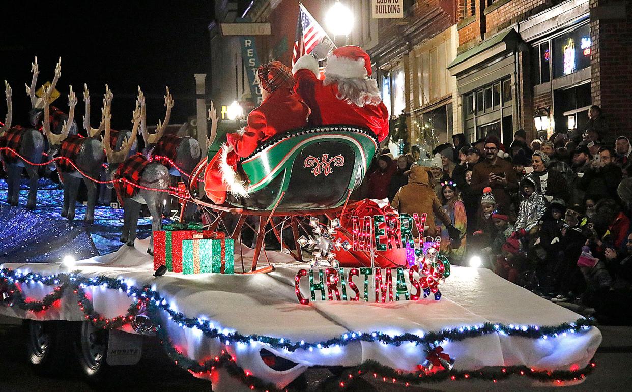 Santa and Mrs. Claus ride on a float in the Ashland's 2021 Christmas parade as it heads down West Main Street on Saturday, Dec. 4, 2021. TOM E. PUSKAR/TIMES-GAZETTE.COM