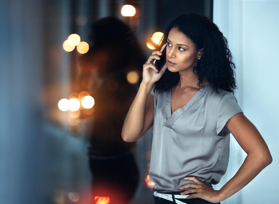 woman waiting on hold on the phone