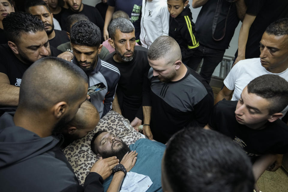 Relatives take a last look at the body of Palestinian Fathi Rizk, 30, at the morgue in the Balata refugee camp near the West Bank town of Nablus Monday, May 22, 2023. The Israeli military raided the camp early Monday, sparking a firefight that killed Rizk and two other Palestinian militants. (AP Photo/Majdi Mohammed)