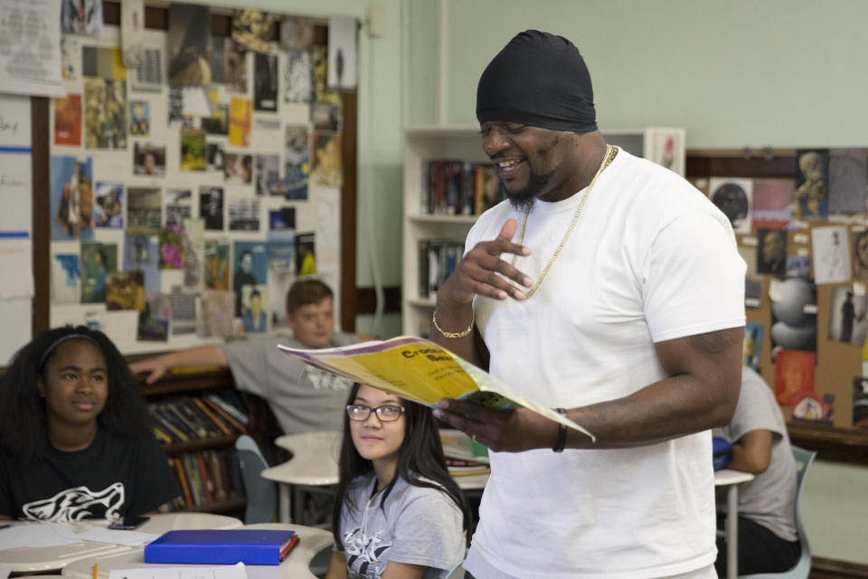 In this image provided by the Des Moines Public Schools, community activist and rap artist Will Keeps works with students at Harding Middle School on Sept. 27, 2017, in Des Moines, Iowa. Students watched his latest music video, 'Droppin' and analyzed his lyrics as part of their literacy class. Keeps is hospitalized in serious condition after surgery following just the sort of violence he's devoted his life to stop -- a shooting that killed two teenagers at the Starts Right Here educational program he founded in Des Moines. Keeps was hurt Monday, Jan. 23, 2023, when he tried to intervene. (Jon Lemons/Des Moines Public Schools via AP)