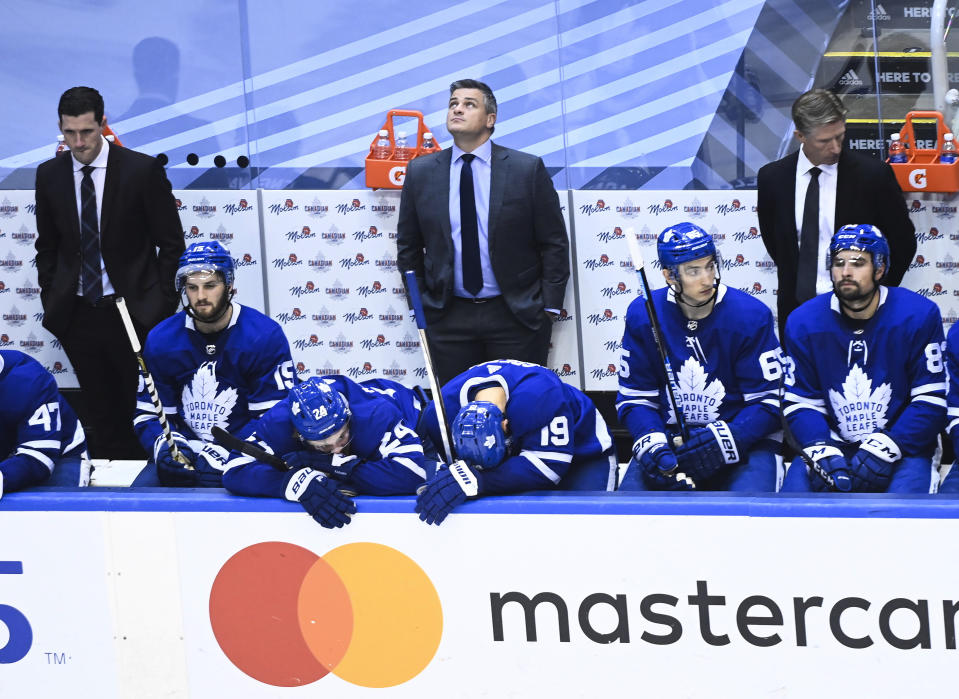 Toronto Maple Leafs coach Sheldon Keefe, back center, and players react late in the third period against the Columbus Blue Jackets in an NHL hockey playoff game Sunday, Aug. 9, 2020, in Toronto. (Nathan Denette/The Canadian Press via AP)