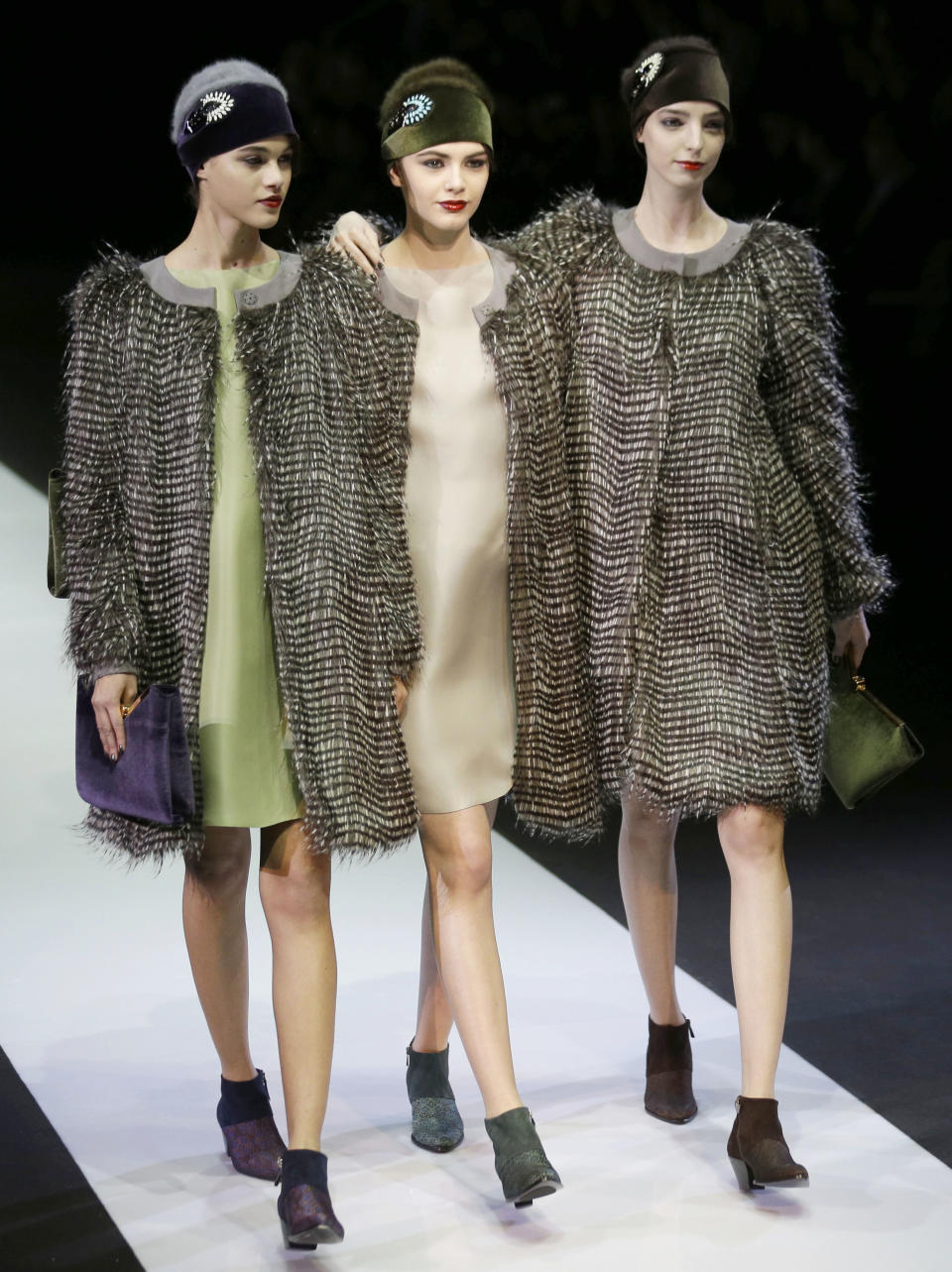 Models wear creations for Emporio Armani women's Fall-Winter 2013-14 collection, part of the Milan Fashion Week, unveiled in Milan, Italy, Sunday, Feb. 24, 2013. (AP Photo/Luca Bruno)