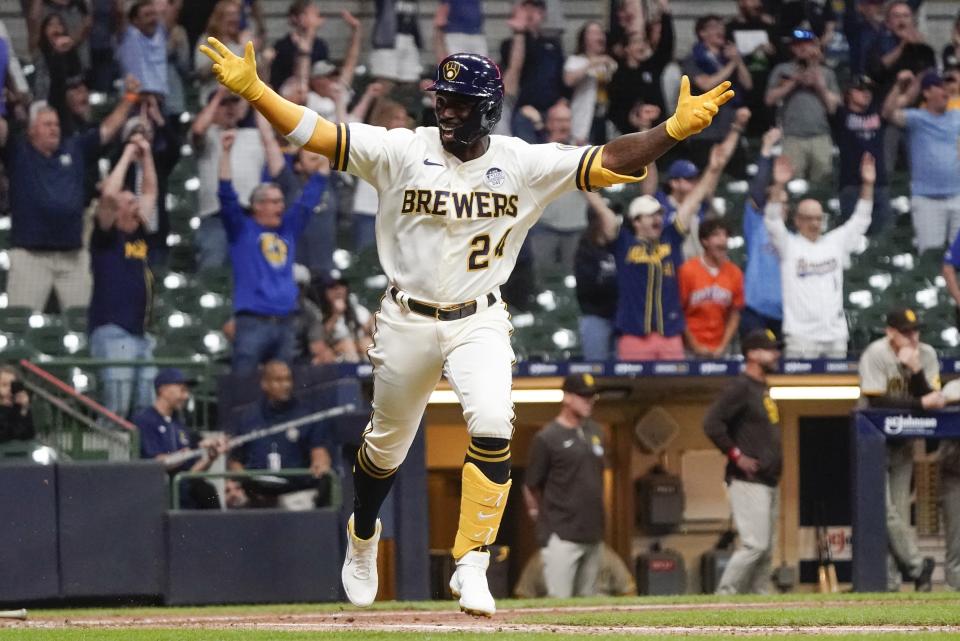 Milwaukee Brewers' Andrew McCutchen celebrates after hitting a walk-off RBI single during the ninth inning of a baseball game against the San Diego Padres Thursday, June 2, 2022, in Milwaukee. The Brewers won 5-4. (AP Photo/Morry Gash)