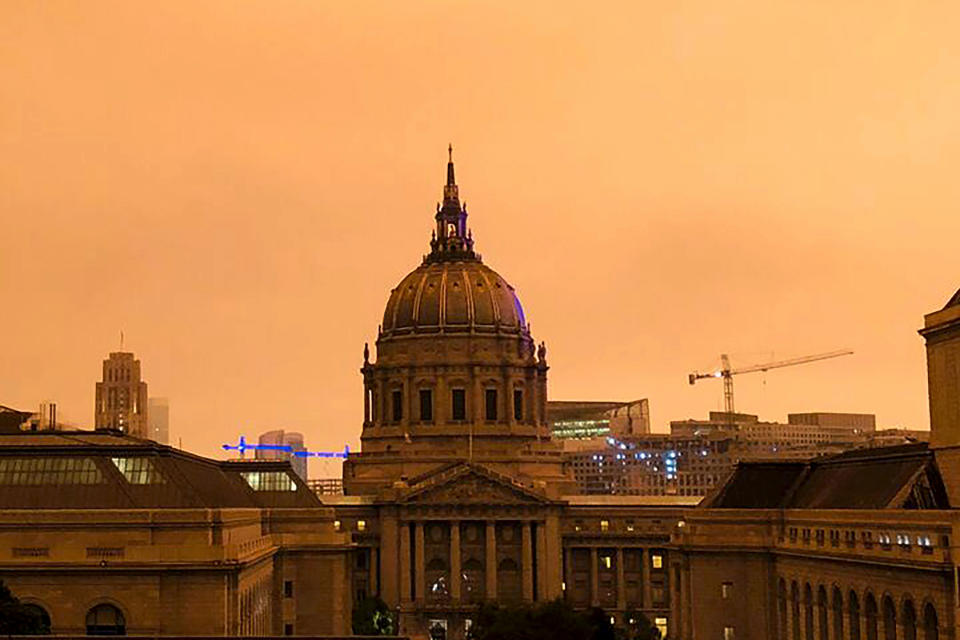 San Francisco City Hall is shrouded in smoke from multiple wildfires burning in the Sierra Nevada and Coast Ranges of Northern California, Wednesday morning, Sept. 9, 2020. Air quality throughout the West was heavily impacted. (AP Photo/Olga Rodriguez)