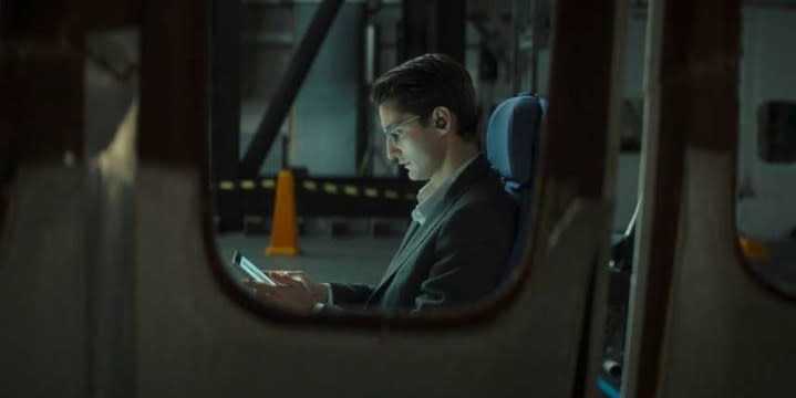 A man looks at his phone in Black Box.