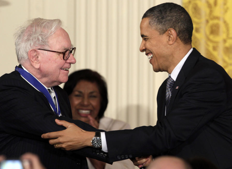 FILE - In this Feb. 15, 2010, file photo President Barack Obama congratulates Warren Buffett after presenting him with a 2010 Presidential Medal of Freedom in an East Room ceremony at the White House in Washington. In his weekly radio and internet address Saturday April 14, 2012, Obama urged Americans to ask their member of Congress to support the "Buffett Rule," named after the billionaire investor who says he pays a lower tax rate than his secretary. Obama says the nation can't afford to keep giving tax cuts to the wealthiest, "who don't need them and didn't even ask for them." (AP Photo/Carolyn Kaster)