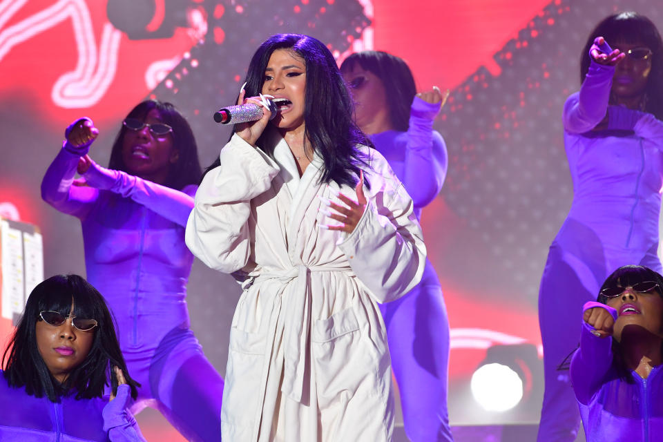 Cardi B performs wearing a white bathrobe during 2019 Bonnaroo Music & Arts Festival on June 16, 2019 in Tennessee.