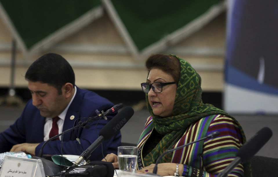 Hawa Alam Nuristani, chief of the Election Commission of Afghanistan, center, speaks during a press conference at the commission's office in Kabul, Afghanistan, Tuesday, Feb. 18, 2020. Afghanistan's independent election commission says President Ashraf Ghani has won a second term as president in a vote that took place on Sept. 28 last year. (AP Photo/Rahmat Gul)