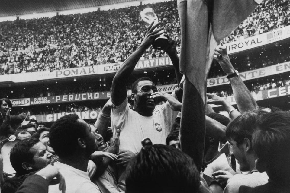 Pele with the World Cup in Mexico City, 1970. Pele scored the first of his team's goals in the match (Popperfoto/Getty Images)