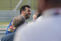 McLaren driver Daniel Ricciardo, of Australia, smiles after driving the late NASCAR driver Dale Earnhardt's iconic 1984 No. 3 Wrangler Chevrolet Monte Carlo before an open practice for the Formula One U.S. Grand Prix auto race at the Circuit of the Americas, Saturday, Oct. 23, 2021, in Austin, Texas. Ricciardo was allowed to drive the car as a reward from his McLaren boss, Zak Brown, for winning his first race with the team. (AP Photo/Eric Gay)