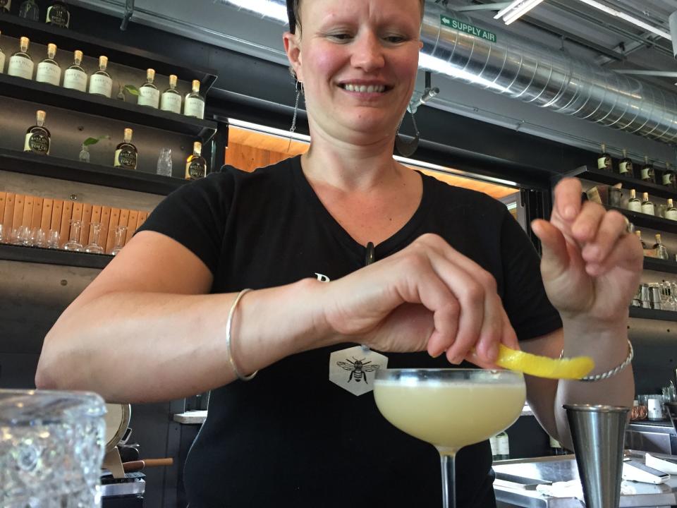 Tara Downs, a bartender at Barr Hill in Montpelier, tops off a Bee's Knees cocktail on Aug. 8, 2019.