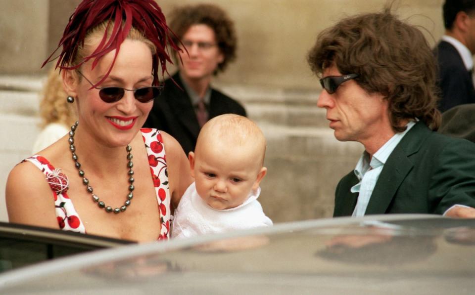 Rolling Stones’ singer Mick Jagger and model Jerry Hall with their baby, Gabriel, attend the wedding of Princess Maria-Theodora ‘Dora’ Loewenstein to Manfredi Gherardesca at the Brompton Oratory on September 27, 1998 in London (Getty Images)