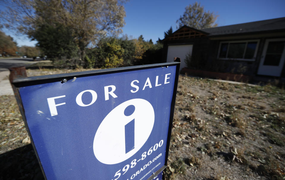 FILE - In this Oct. 22, 2019, file photo a sign stands outside a home for sale in southeast Denver. On Thursday, Dec. 5, Freddie Mac reports on this week's average U.S. mortgage rates. (AP Photo/David Zalubowski)