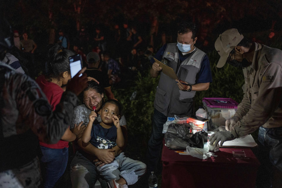FILE - Migrants, mainly from Central America, who were traveling to the U.S. inside a tractor-trailer, are detained by Mexican immigration agents and National Guard members in Veracruz, Mexico, July 23, 2023. (AP Photo/Felix Marquez, File)