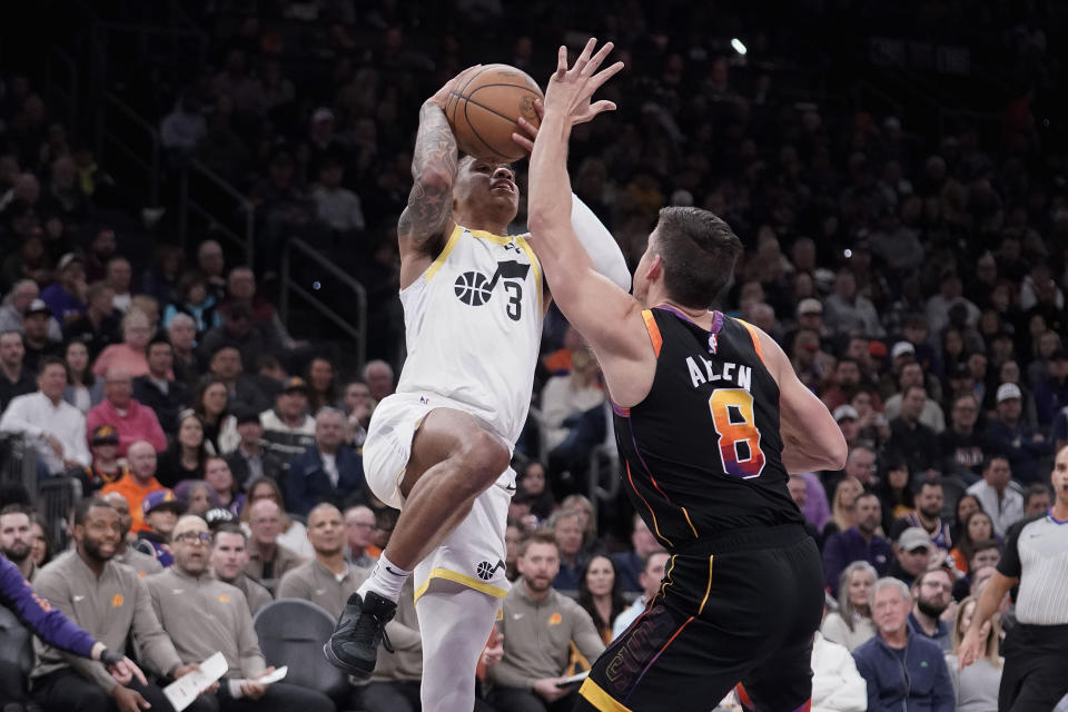 Utah Jazz's Keyonte George (3) drives to the basket against Phoenix Suns' Grayson Allen (8) during the first half of an NBA basketball game in Phoenix, Thursday, Jan. 8, 2024. (AP Photo/Darryl Webb)